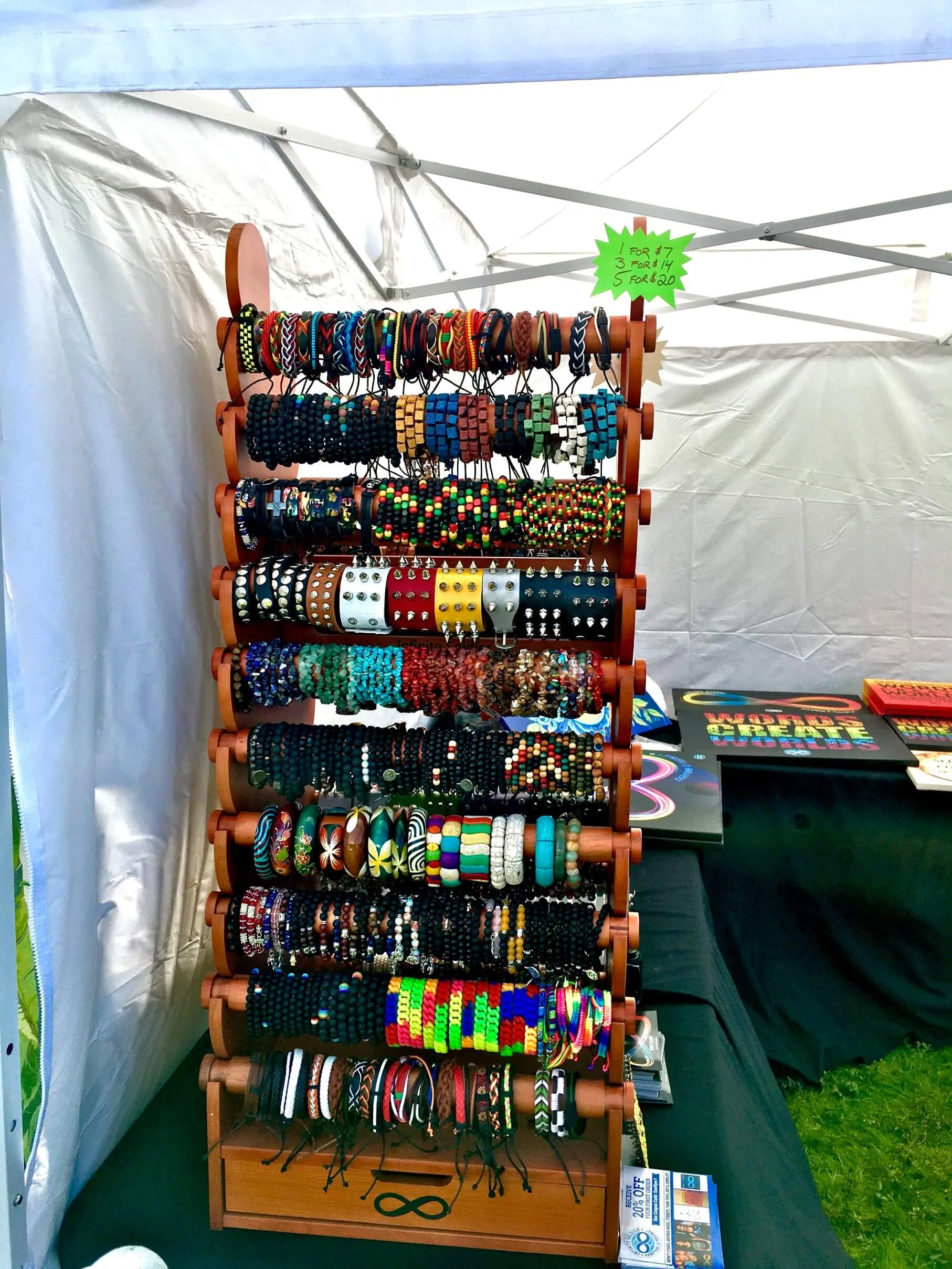 The display used as a retail fixture inside a store, holding beaded bracelets